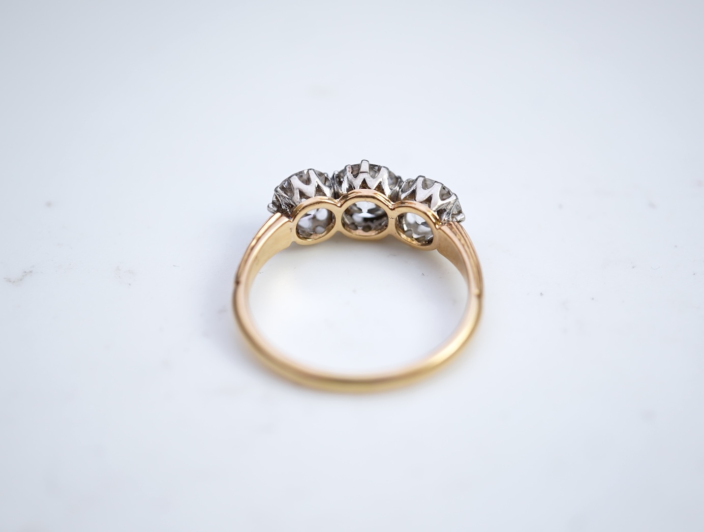 An attractive three-stone diamond ring, early 20th century